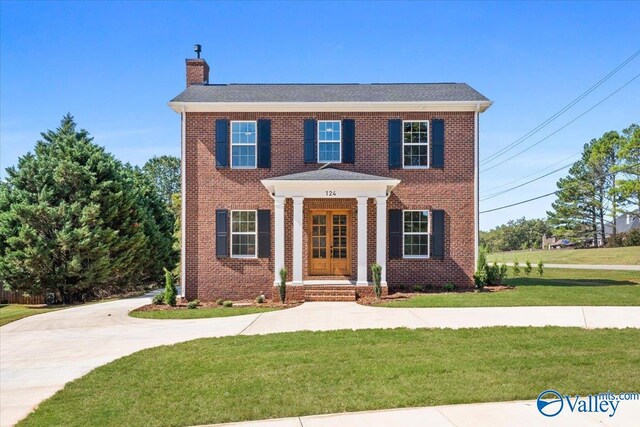 colonial-style house featuring central air condition unit