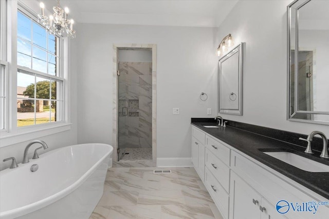 bathroom featuring a soaking tub, a stall shower, marble finish floor, and a sink