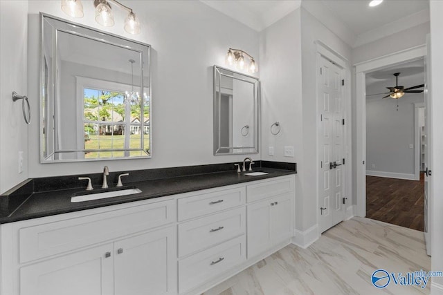 bathroom with ceiling fan, double vanity, a sink, and baseboards