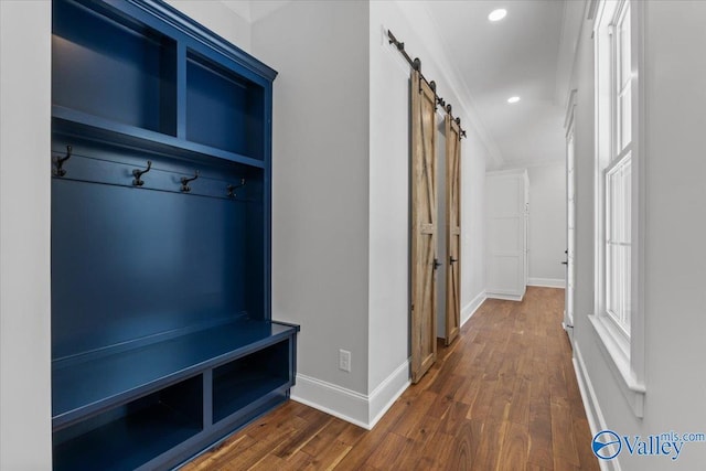 mudroom with dark wood-style floors, a barn door, recessed lighting, and baseboards