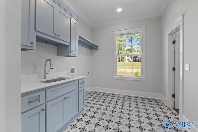 interior space with light countertops, a sink, and baseboards