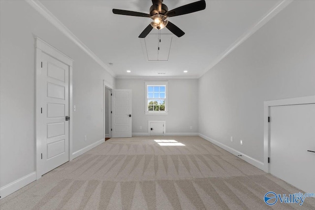 carpeted spare room with attic access, ornamental molding, baseboards, and recessed lighting