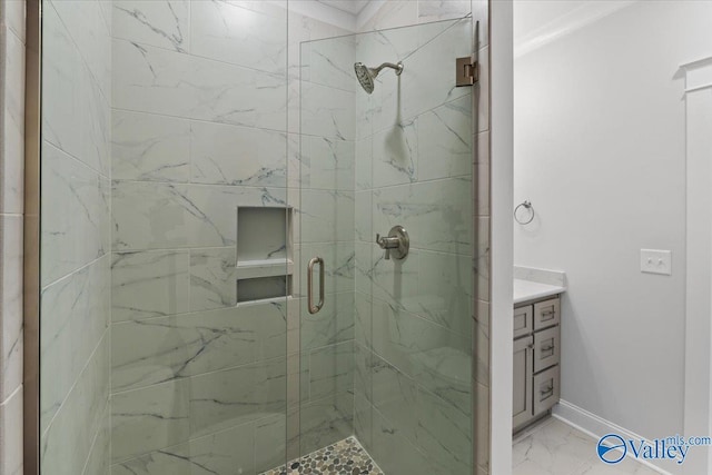 full bathroom featuring marble finish floor, a shower stall, vanity, and baseboards