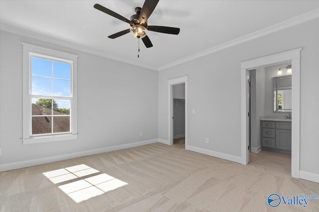 unfurnished bedroom with ornamental molding, light carpet, and baseboards