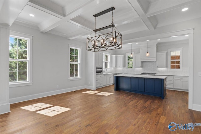 kitchen featuring dark wood-type flooring, decorative backsplash, and baseboards