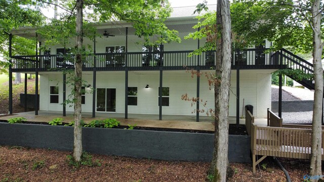 rear view of property with a deck and a patio