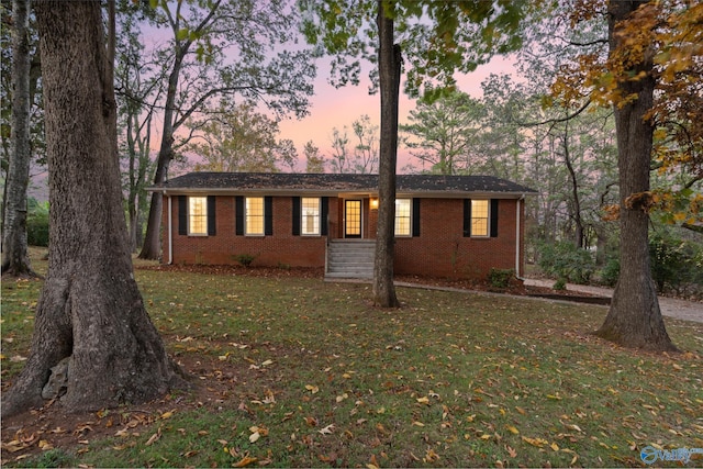 ranch-style house featuring a yard