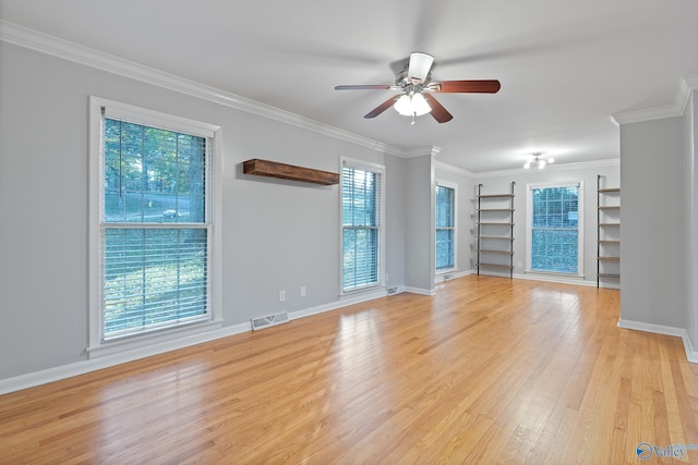 spare room with ceiling fan, ornamental molding, and light wood-type flooring