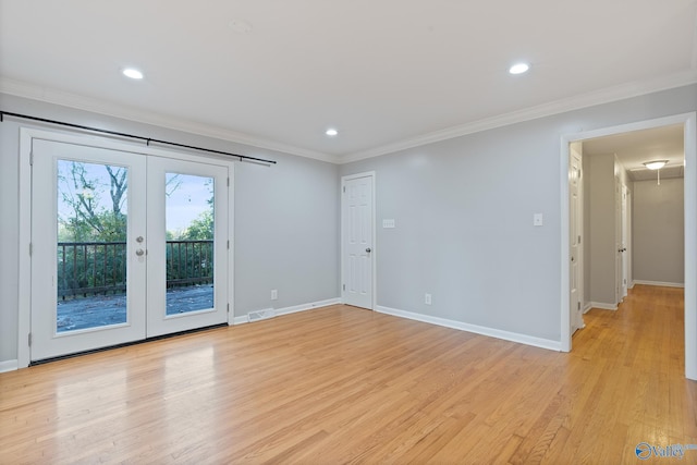 spare room with light hardwood / wood-style floors, ornamental molding, and french doors