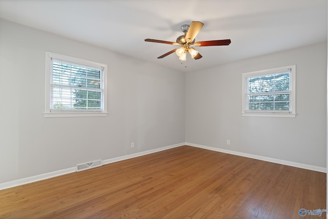 unfurnished room with ceiling fan and wood-type flooring