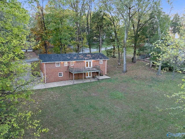 rear view of house featuring a patio area, a yard, and a wooden deck