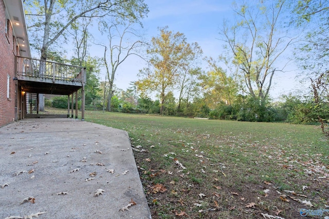 view of yard featuring a patio and a deck