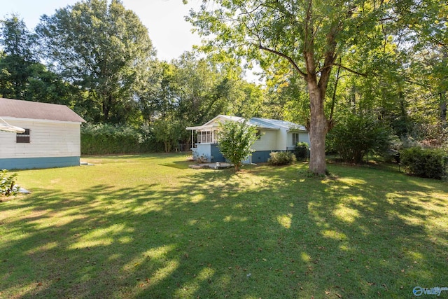 view of yard featuring a sunroom