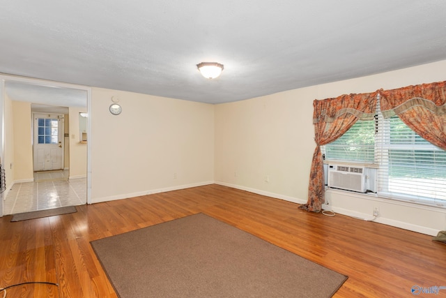 spare room with wood-type flooring and a textured ceiling