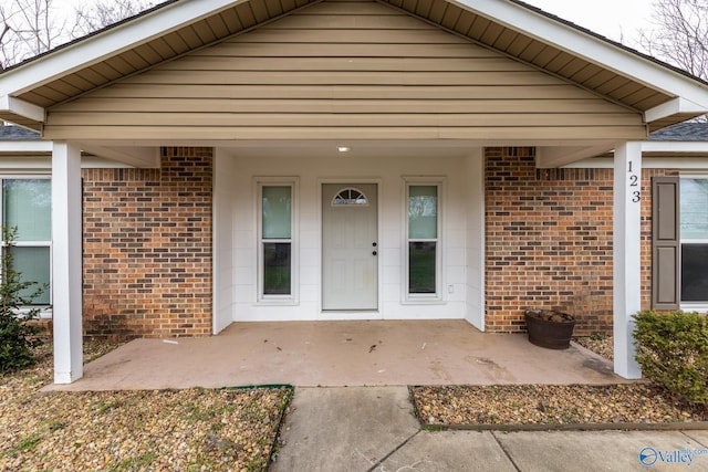 view of exterior entry with covered porch