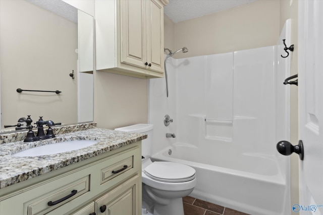 full bath with tile patterned floors, toilet, vanity,  shower combination, and a textured ceiling