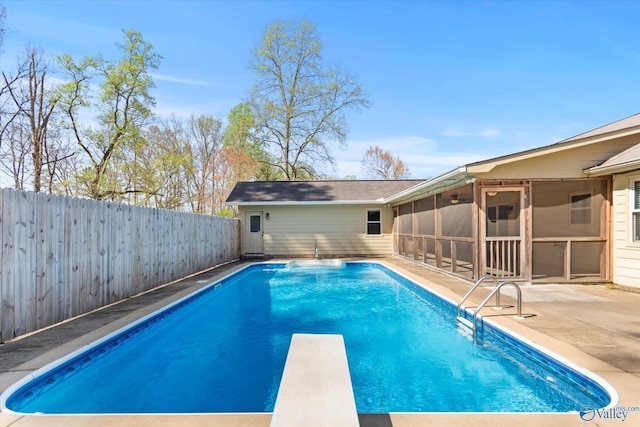 view of pool with a sunroom, a patio, a diving board, a fenced backyard, and a fenced in pool