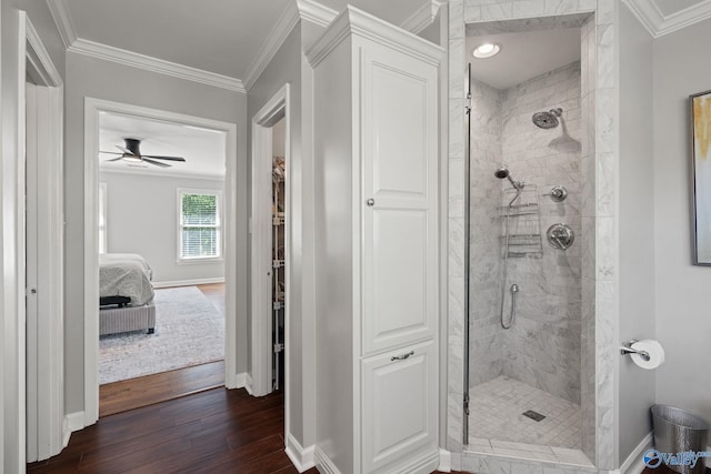 bathroom featuring ornamental molding, a tile shower, ceiling fan, and hardwood / wood-style floors