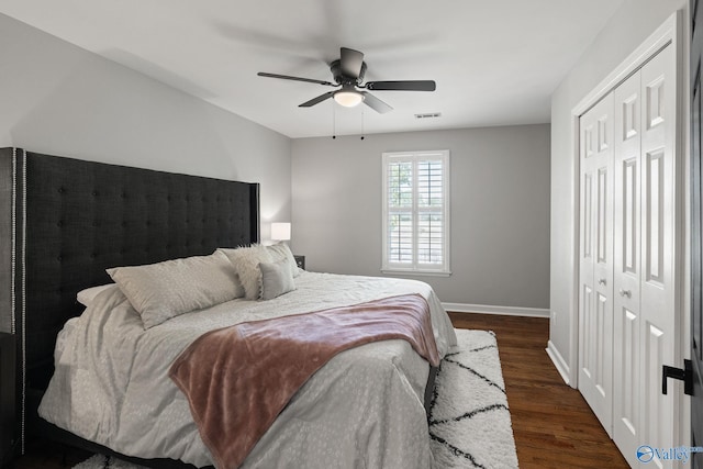 bedroom featuring ceiling fan, a closet, and dark hardwood / wood-style floors