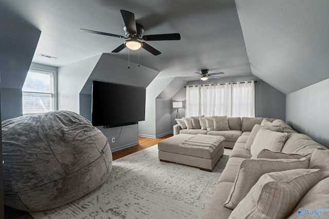 living room featuring ceiling fan, vaulted ceiling, and light hardwood / wood-style floors