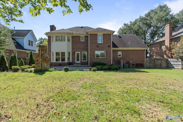 rear view of house featuring a lawn, a patio, and central air condition unit