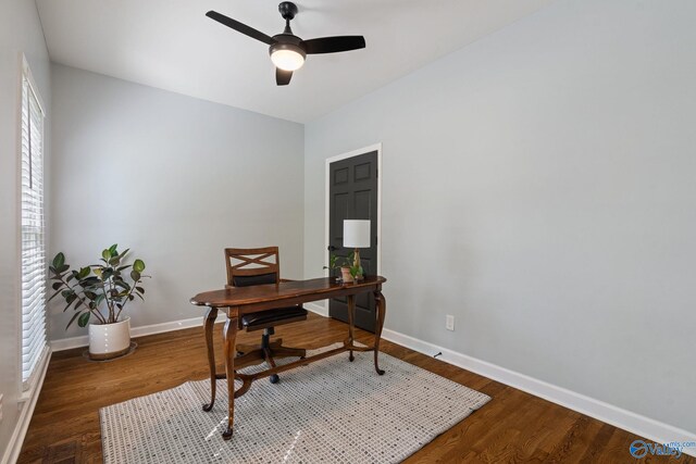 home office featuring ceiling fan and dark wood-type flooring