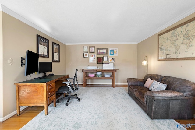 office area featuring ornamental molding, baseboards, and wood finished floors