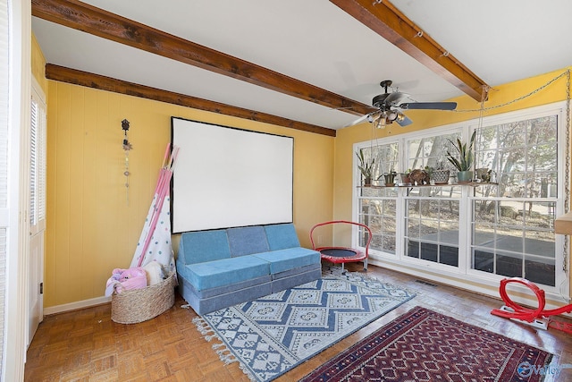 interior space featuring visible vents, beamed ceiling, and ceiling fan