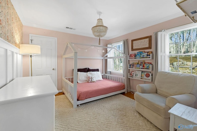 bedroom featuring ornamental molding, visible vents, and light wood-style floors