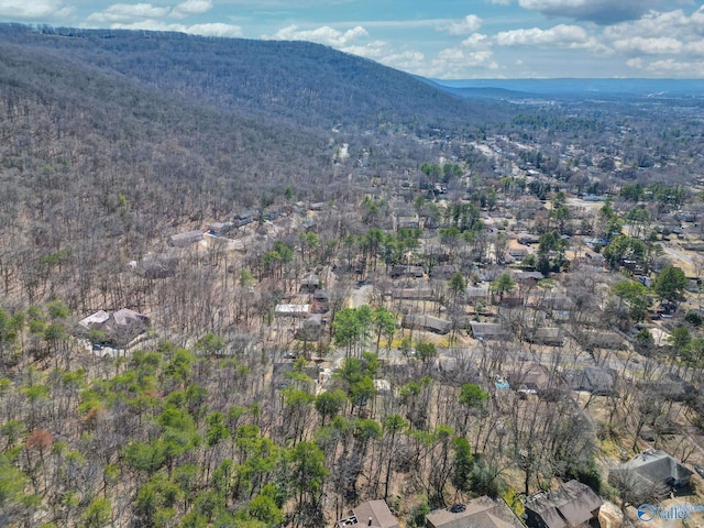 drone / aerial view with a mountain view and a view of trees