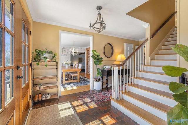 entryway featuring brick floor, crown molding, stairway, and a notable chandelier