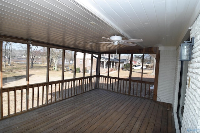 unfurnished sunroom with wooden ceiling and ceiling fan