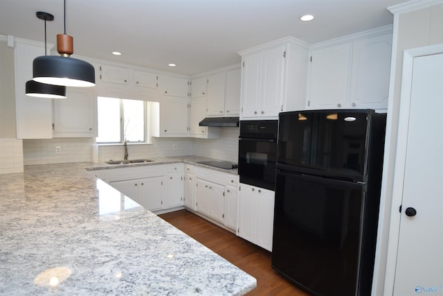 kitchen with sink, white cabinetry, black appliances, pendant lighting, and backsplash