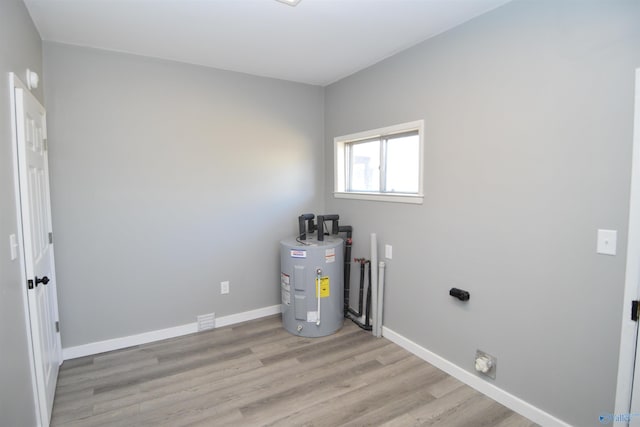 utility room featuring electric water heater