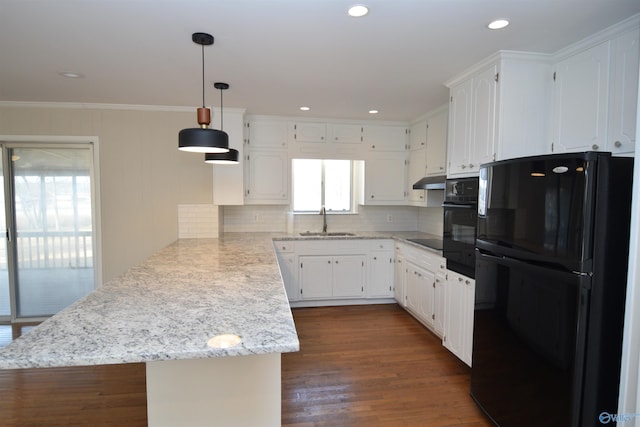 kitchen featuring decorative light fixtures, black appliances, white cabinetry, sink, and kitchen peninsula