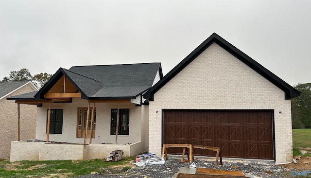 view of front of home with a porch and a garage