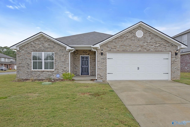 view of front of property with a garage and a front lawn