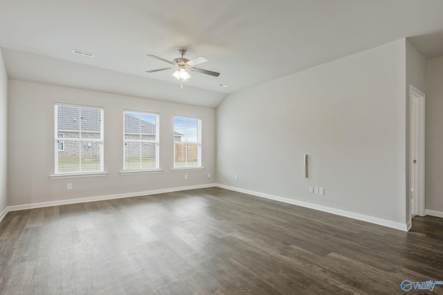 spare room featuring ceiling fan, dark hardwood / wood-style floors, and vaulted ceiling