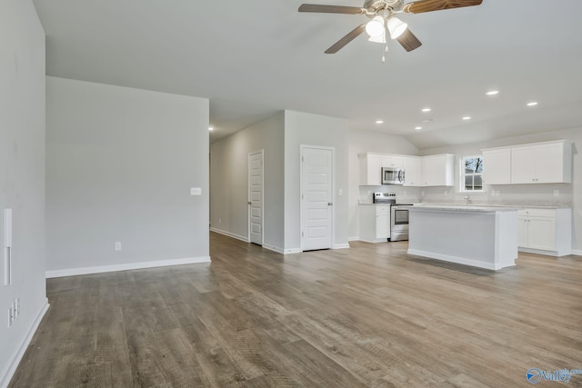 interior space with ceiling fan, sink, and light hardwood / wood-style floors