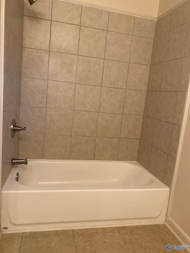 bathroom featuring tile patterned flooring and tiled shower / bath