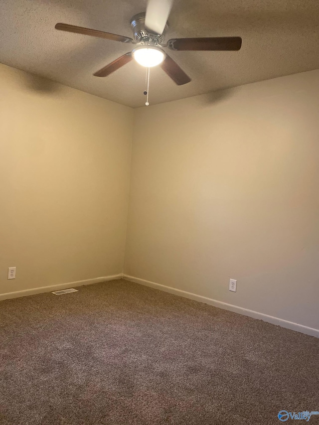 unfurnished room featuring carpet, ceiling fan, and a textured ceiling