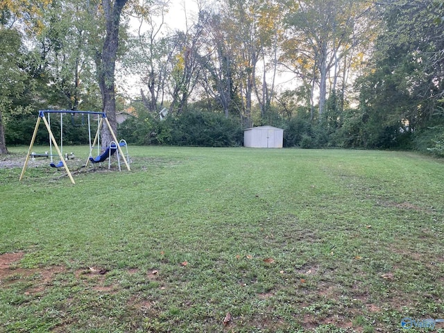 view of yard featuring a playground and a storage unit