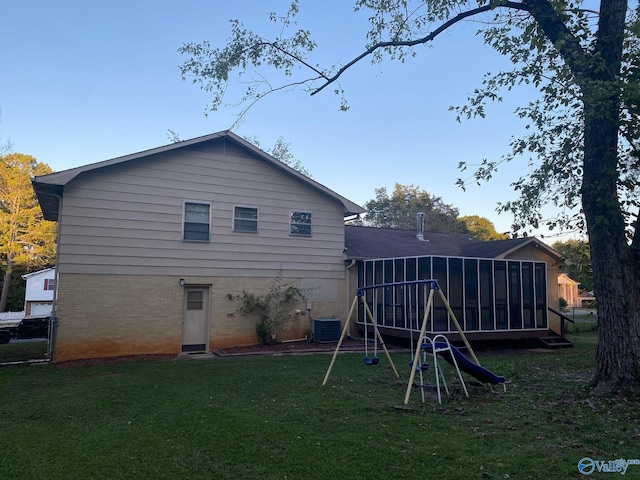 rear view of house featuring a wooden deck, cooling unit, and a yard