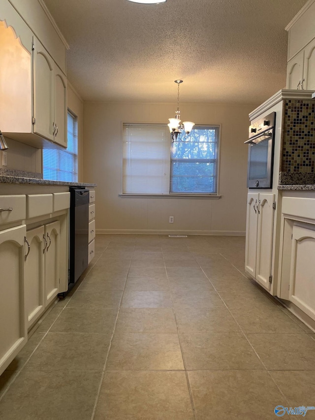 kitchen with pendant lighting, black dishwasher, a chandelier, oven, and light tile patterned floors