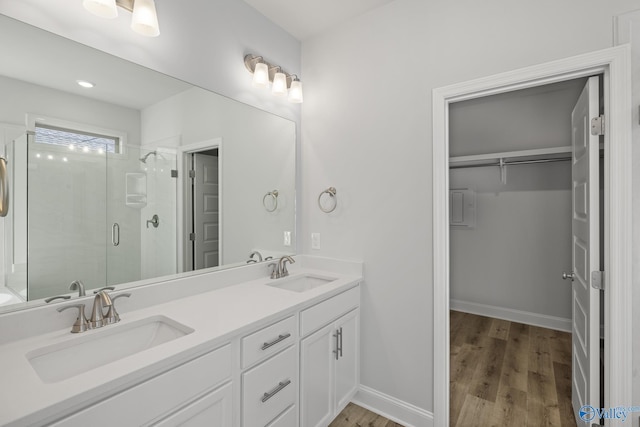 304 Wanto Ln, Huntsville, AL 35811 - full bath featuring a shower stall, a spacious closet, double vanity, and wood finished floors