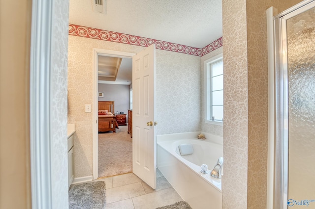 full bathroom featuring a garden tub, a textured ceiling, connected bathroom, and wallpapered walls