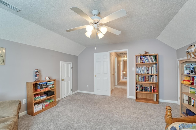 living area with vaulted ceiling, carpet, visible vents, and ceiling fan