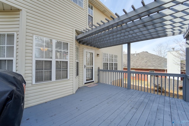 deck with grilling area and a pergola