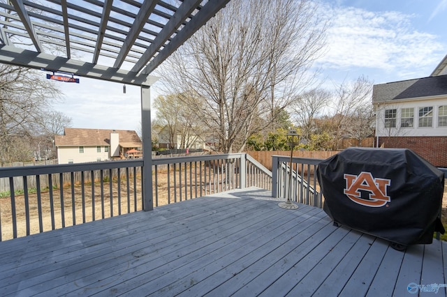 wooden terrace featuring a fenced backyard and a pergola