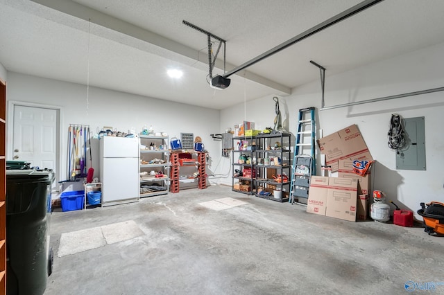 garage with electric panel, a garage door opener, and freestanding refrigerator